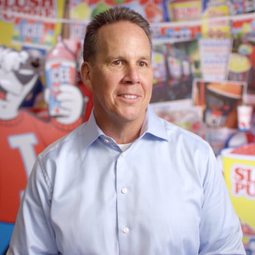 A man standing in front of an ICEE background